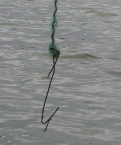 Tamp, tjock ståltråd som hittades i en f.d. lägereld samt masken: fastknuten runt sig själv.